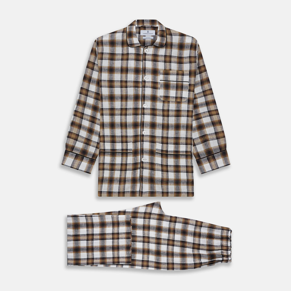 The Turnbull & Asser Brown Multi Check Linen Hyde Pyjama Set features a button-up, long-sleeve top and pants with a brown, black, and white plaid pattern, shown on a white background.