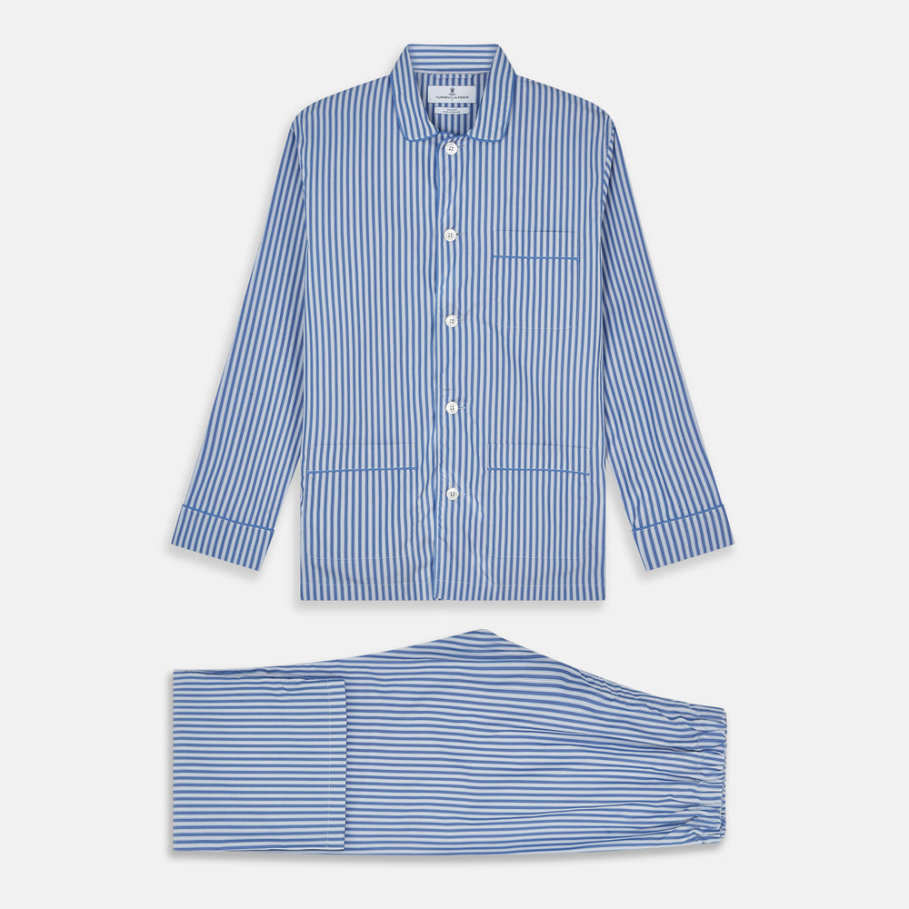 The Blue Multi Cotton Hyde Pyjama Set by Turnbull & Asser features a long-sleeve button-up top with chest pocket and matching elastic waist pants in blue and white stripes, crafted from soft Italian cotton and displayed on a white background.