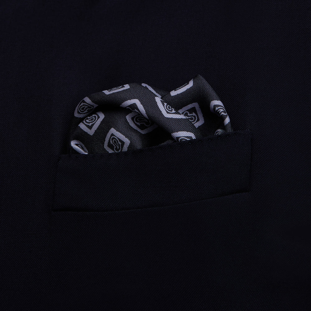 The Turnbull & Asser Navy Cubed Paisley Silk Pocket Square features a dark navy base with a repeating white square and diamond pattern, finished with a geometric border and “Turnbull & Asser” in the corners.