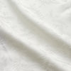 View 2 of product The Cream Floral Pattern Silk Harriet Women's Pyjama Set by Turnbull & Asser features long sleeves, pants, dark piping, a chest pocket, and luxurious silk fabric with a cream floral design, shown on a plain white background.