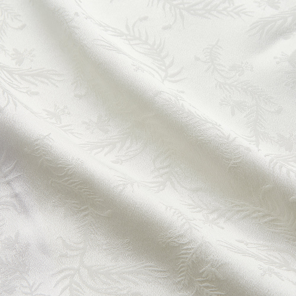 The Cream Floral Pattern Silk Harriet Women's Pyjama Set by Turnbull & Asser features long sleeves, pants, dark piping, a chest pocket, and luxurious silk fabric with a cream floral design, shown on a plain white background.
