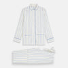View 5 of product The Turnbull & Asser Women's Blue Multi Cotton Thelma Pyjama Set features a long-sleeve button-up shirt with collar and pocket, plus matching drawstring pants, elegantly displayed against a white background.