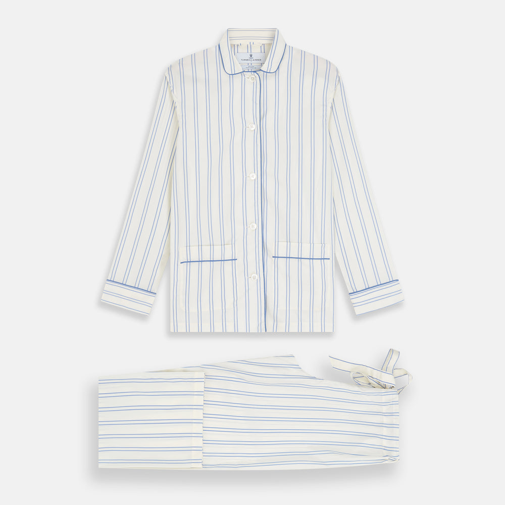 The Turnbull & Asser Women's Blue Multi Cotton Thelma Pyjama Set features a long-sleeve button-up shirt with collar and pocket, plus matching drawstring pants, elegantly displayed against a white background.