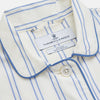View 2 of product The Turnbull & Asser Women's Blue Multi Cotton Thelma Pyjama Set features a long-sleeve button-up shirt with collar and pocket, plus matching drawstring pants, elegantly displayed against a white background.
