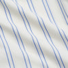 View 4 of product The Turnbull & Asser Women's Blue Multi Cotton Thelma Pyjama Set features a long-sleeve button-up shirt with collar and pocket, plus matching drawstring pants, elegantly displayed against a white background.