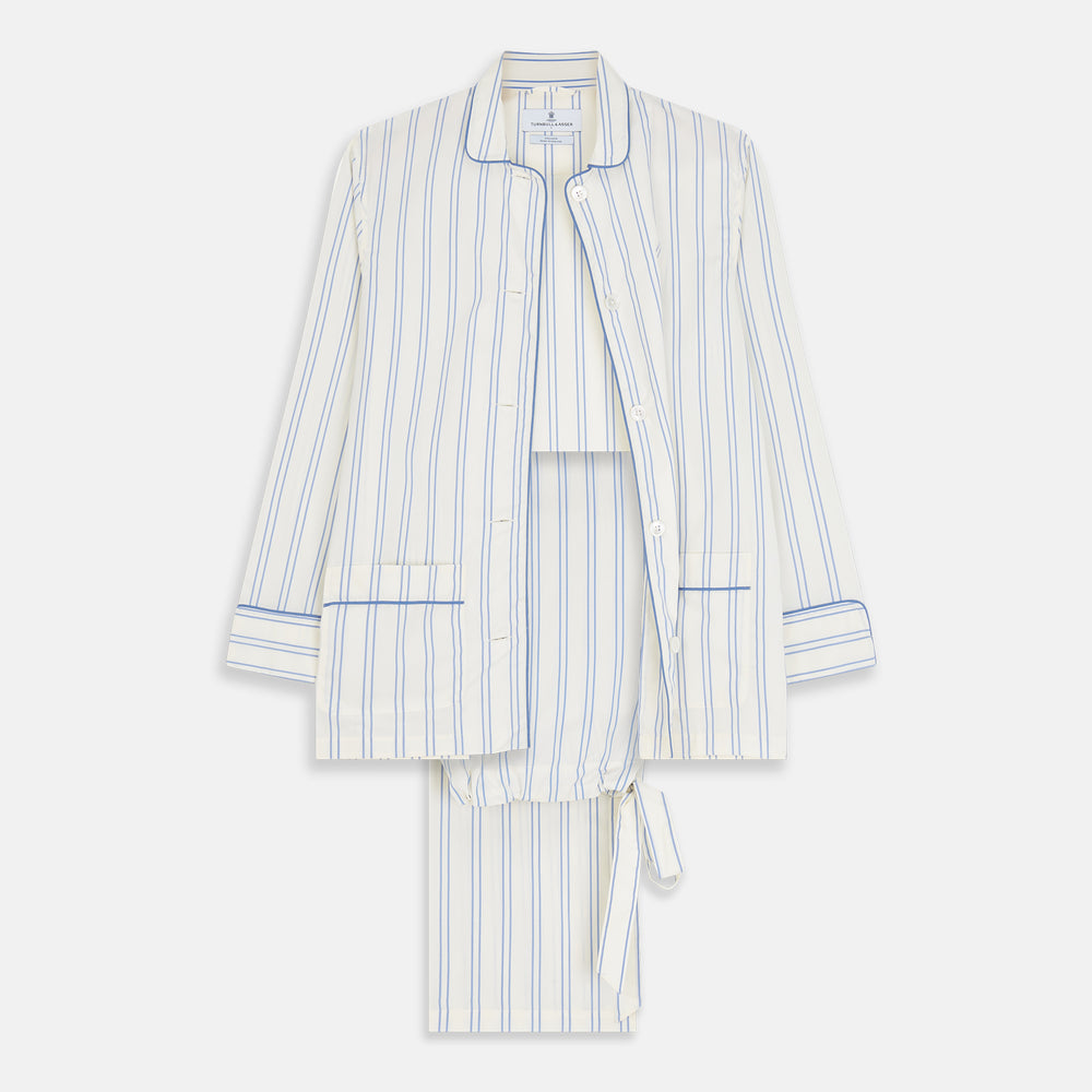 The Turnbull & Asser Women's Blue Multi Cotton Thelma Pyjama Set features a long-sleeve button-up shirt with collar and pocket, plus matching drawstring pants, elegantly displayed against a white background.