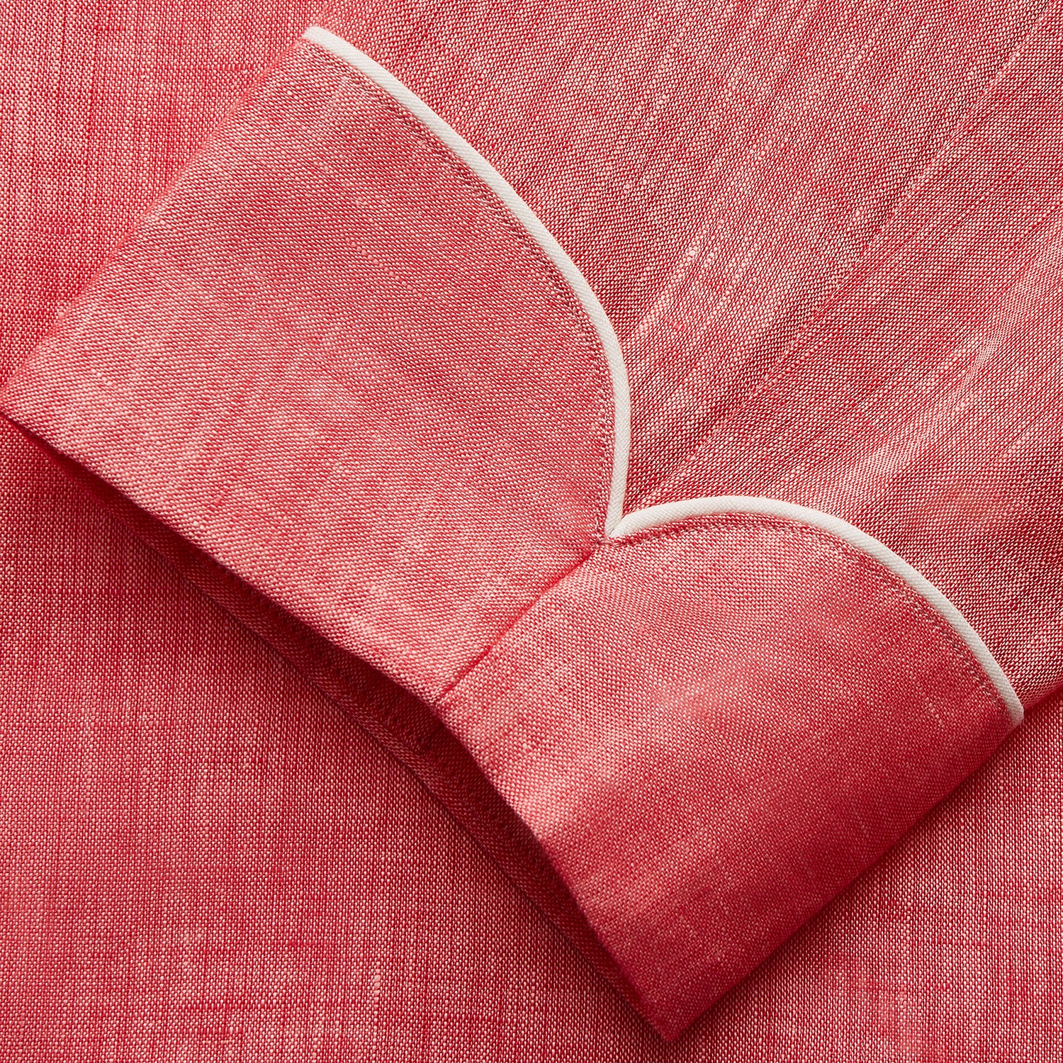 View 3 of product The Pink Linen Arnold Gown by Turnbull & Asser features white piping, long sleeves, a shawl collar, chest pocket, and a wrap-around belt tied at the waist, shown on a white background.