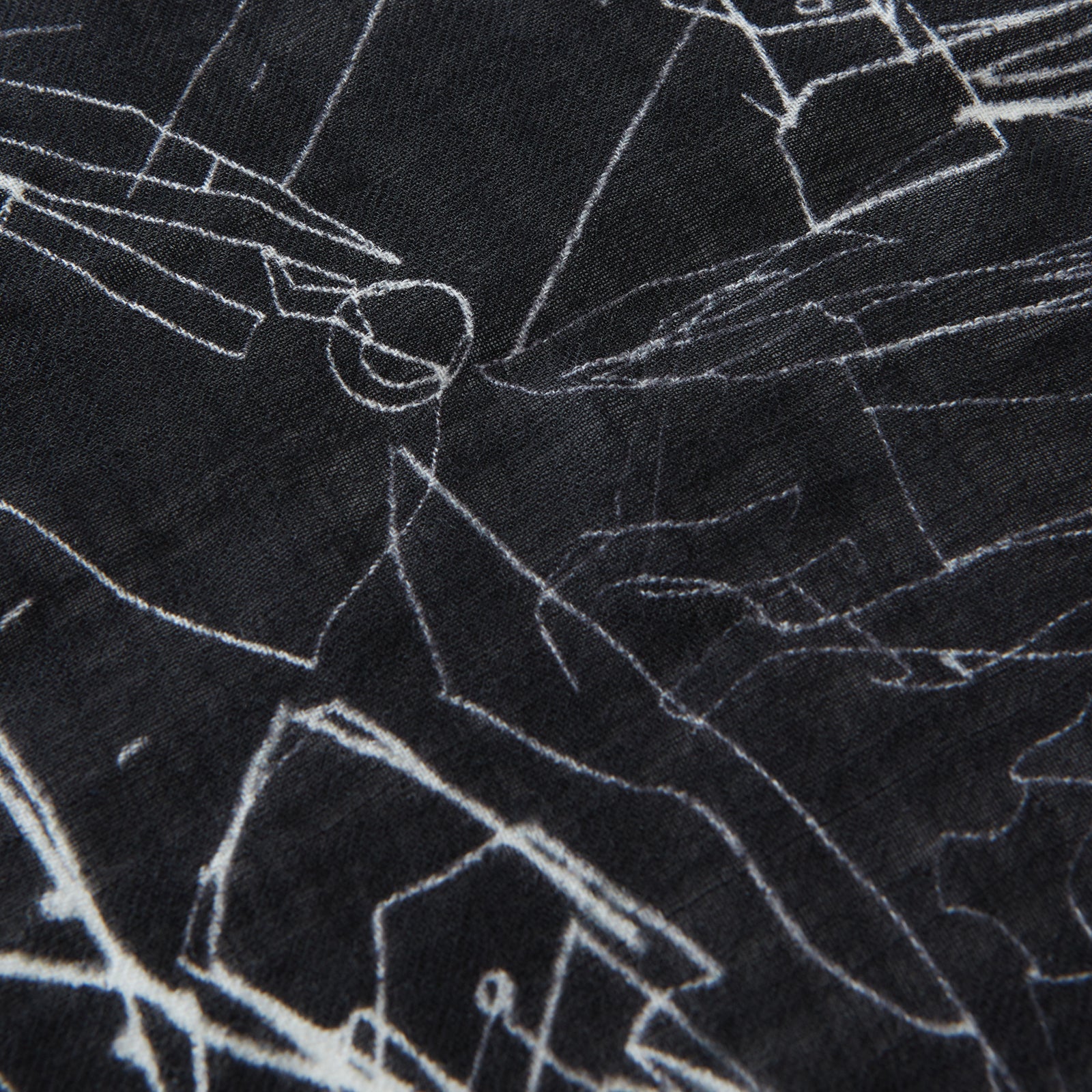 View 2 of product The Turnbull & Asser Black Sketched Pattern Wool Chilcott Scarf features white abstract lines, frayed edges, and is shown loosely knotted on a light gray background.