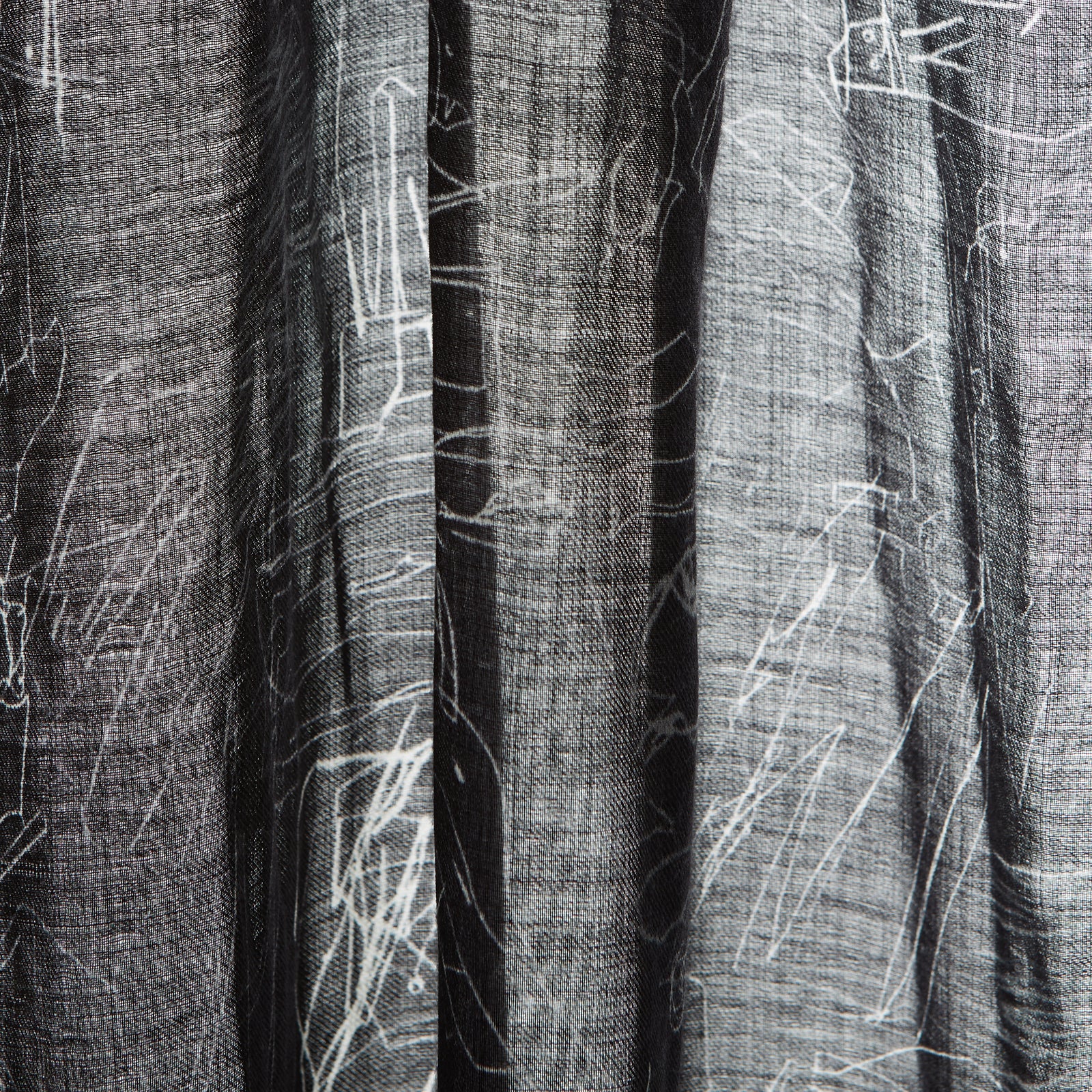 View 5 of product The Turnbull & Asser Black Sketched Pattern Wool Chilcott Scarf features white abstract lines, frayed edges, and is shown loosely knotted on a light gray background.