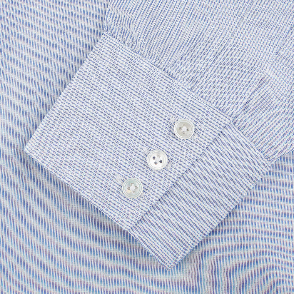 The Turnbull & Asser Blue and White Stripe Cotton Regular Fit Mayfair Shirt features long sleeves, a T&A collar, white buttons, and buttoned cuffs, displayed flat on a white background.
