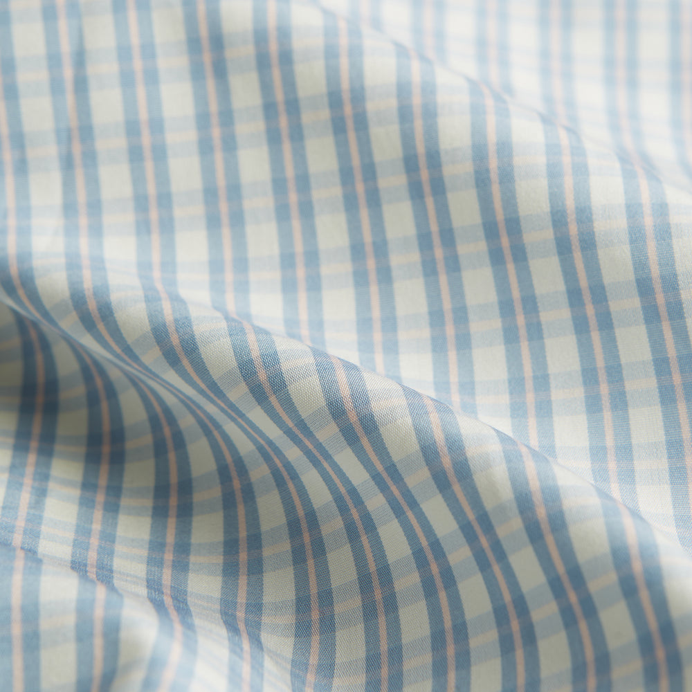 The Turnbull & Asser Pale Blue Multi Check Cotton Regular Fit Mayfair Shirt features long sleeves and a button-up front, displayed against a plain white background.
