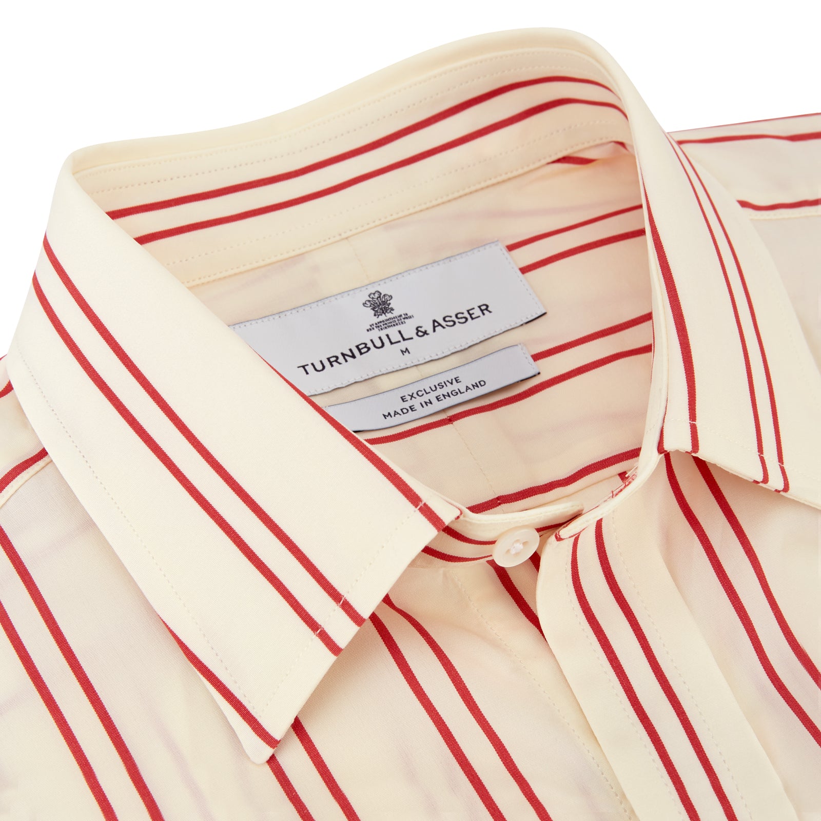 View 3 of product A man poses against a beige backdrop in the Turnbull & Asser Red and Off-White Stripe Cotton Weekend Fit Finch Shirt, styled with dark blue jeans and a brown belt for a timeless look. One hand rests in his pocket as he faces slightly to the side.