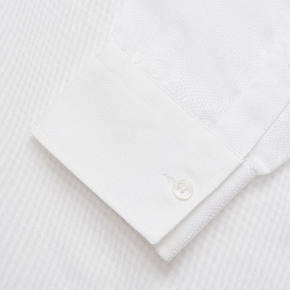 The Turnbull & Asser White Cotton Voile Weekend Fit Nevis Shirt features a Dorset button-down collar, two chest pockets, and a subtle military-inspired design, shown against a plain white background.