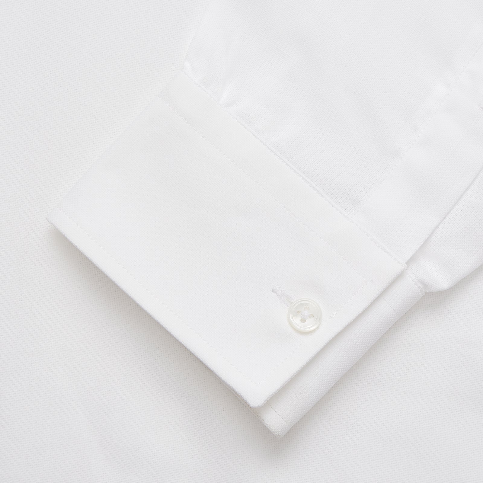 View 3 of product The Turnbull & Asser White Cotton Voile Weekend Fit Nevis Shirt features a Dorset button-down collar, two chest pockets, and a subtle military-inspired design, shown against a plain white background.
