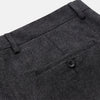 View 2 of product Turnbull & Asser Charcoal Black Wool Manson Trousers feature a tailored fit, front crease, belt loops, and side pockets, crafted from premium virgin wool and shown against a plain white background.