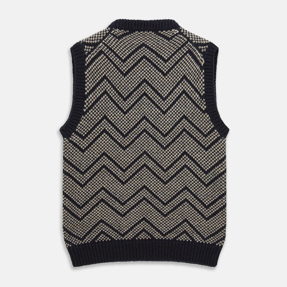 The Turnbull & Asser Navy and White Wool Blend Albion Chunky Slipover is a sleeveless knitted vest with ribbed V-neck, armholes, and hem, featuring a bold chevron pattern.