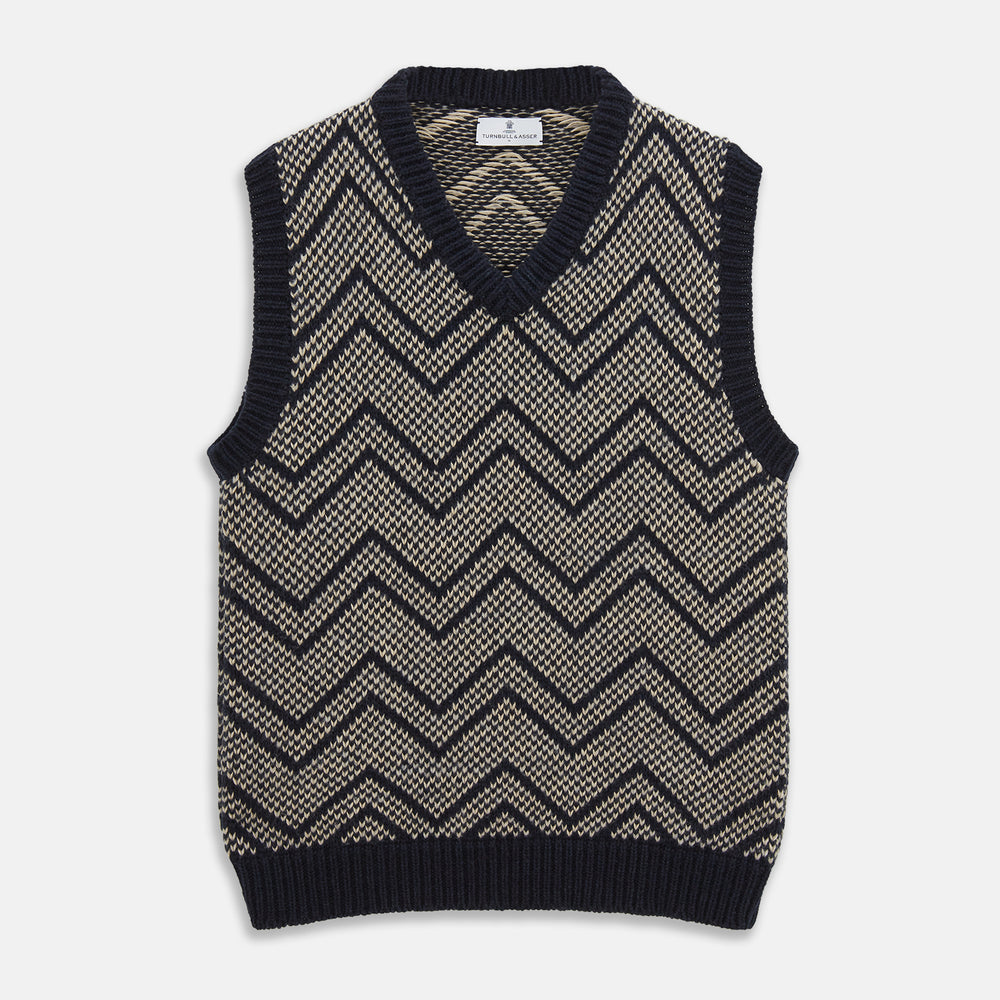The Turnbull & Asser Navy and White Wool Blend Albion Chunky Slipover is a sleeveless knitted vest with ribbed V-neck, armholes, and hem, featuring a bold chevron pattern.