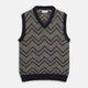 The Turnbull & Asser Navy and White Wool Blend Albion Chunky Slipover is a sleeveless knitted vest with ribbed V-neck, armholes, and hem, featuring a bold chevron pattern.