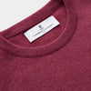 View 2 of product The Turnbull & Asser Soft Burgundy Cashmere Glenn Jumper, a menswear essential with long sleeves and a crew neck in solid dark red, is laid flat on a white background.