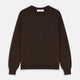 The Turnbull & Asser Brown Cashmere Glenn Jumper is a classic menswear piece with a crew neck and ribbed cuffs, collar, and hem. It’s laid flat on a white background, showcasing its timeless long-sleeved design.