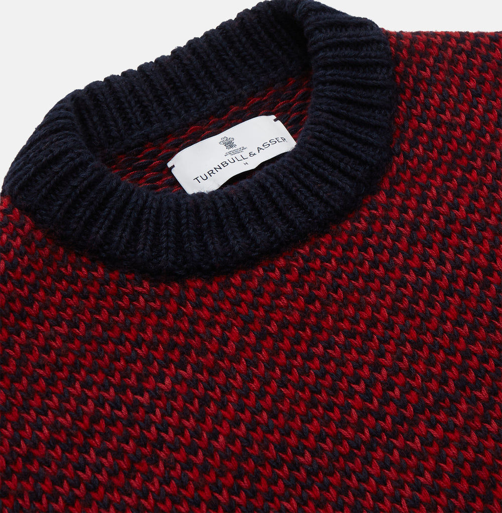 The Turnbull & Asser Red and Navy Wool Blend Billy Jumper features a red knit body with navy ribbed collar, cuffs, and hem, made from a wool and cotton blend, shown on a white background.
