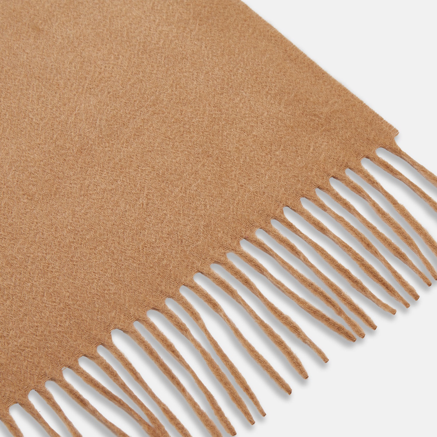 View 2 of product The Turnbull & Asser Camel Brown Cashmere Scarf features soft cashmere and fringed ends, neatly folded on a white background—an essential winter accessory.