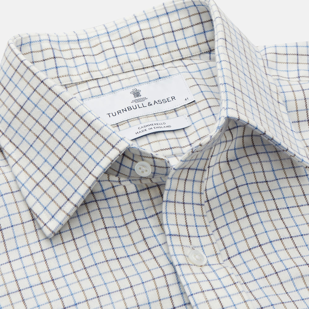 The Turnbull & Asser Blue Tattersall Check Cashmerello Regular Fit Mayfair Shirt is a long-sleeve button-up with a collar and chest pocket, featuring a white base and blue checks, shown laid flat on a white background.