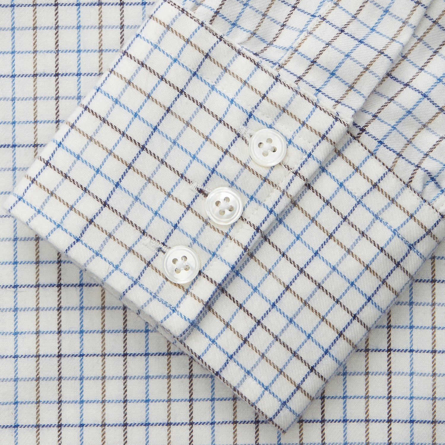 View 2 of product The Turnbull & Asser Blue Tattersall Check Cashmerello Regular Fit Mayfair Shirt is a long-sleeve button-up with a collar and chest pocket, featuring a white base and blue checks, shown laid flat on a white background.