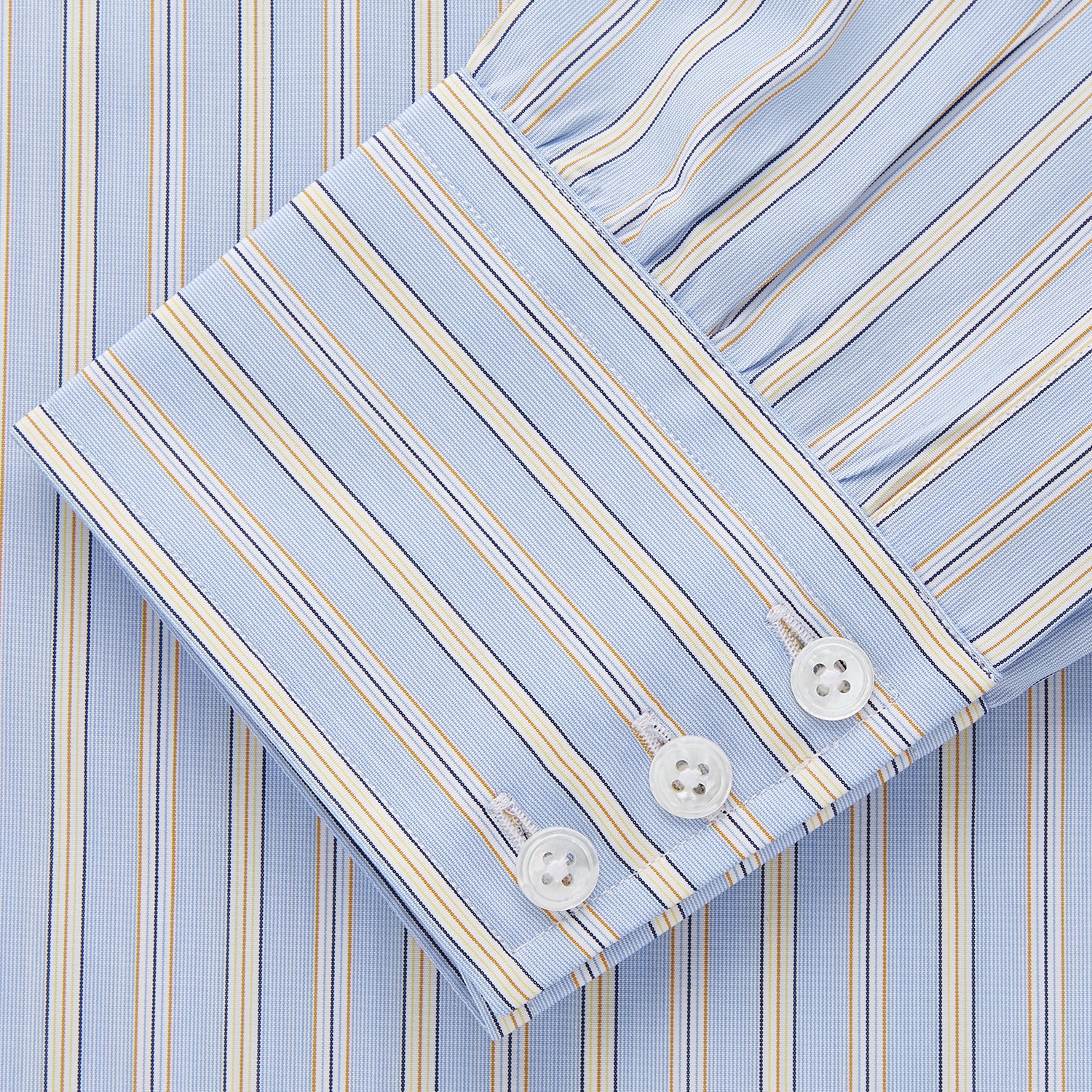 View 2 of product The Turnbull & Asser Blue and Yellow Multi Stripe Cotton Regular Fit Mayfair Shirt features thin vertical stripes in white, blue, and tan, a collared design with white buttons—an essential formal staple for any man’s wardrobe.