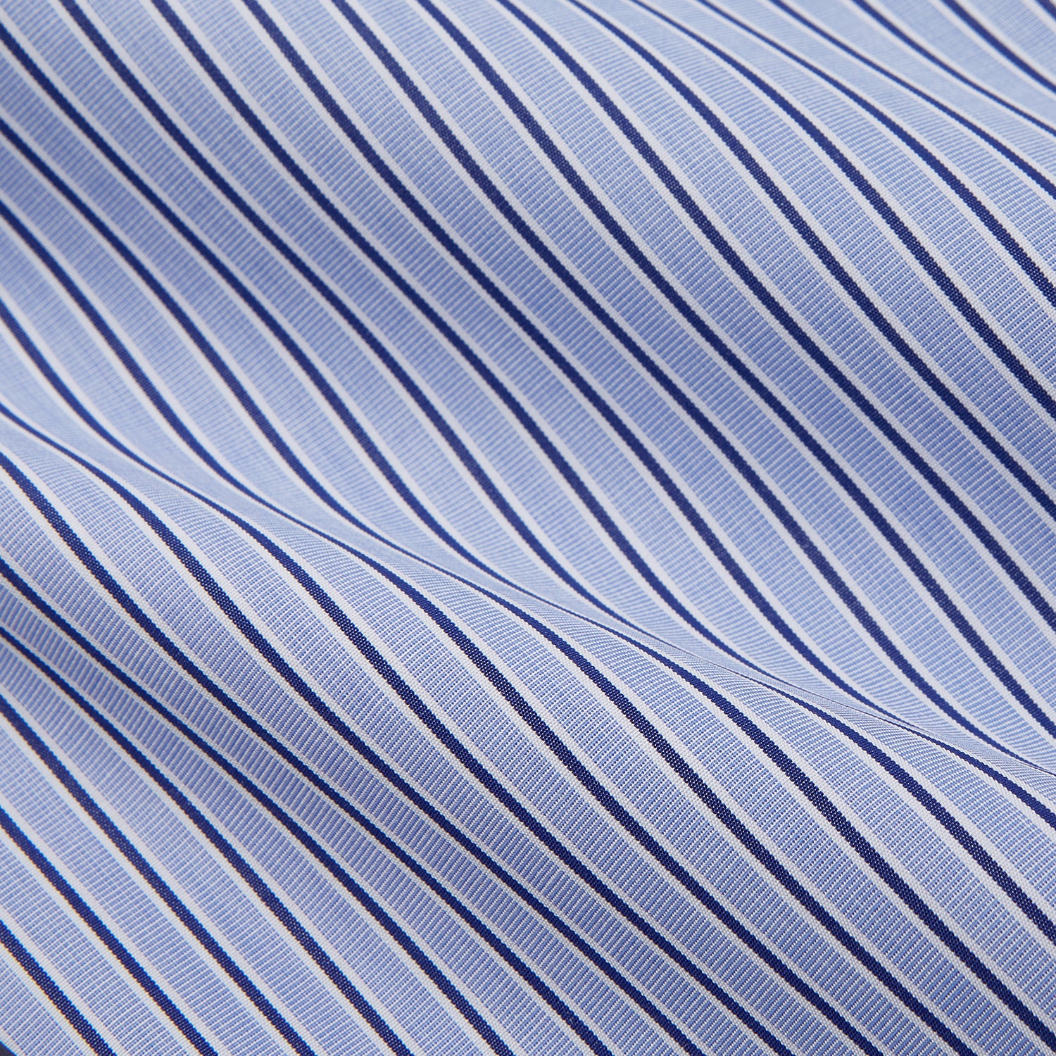View 4 of product The Blue and Navy Halo Stripe Cotton Regular Fit Mayfair Shirt by Turnbull & Asser features classic styling with vertical stripes, a button-up front, and cuffed sleeves—an essential men's wardrobe piece.