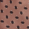 View 2 of product The Bronze and Chocolate Brown Tile Silk Tie by Turnbull & Asser features a classic tile pattern with small black graduation caps, neatly rolled on a plain white background.