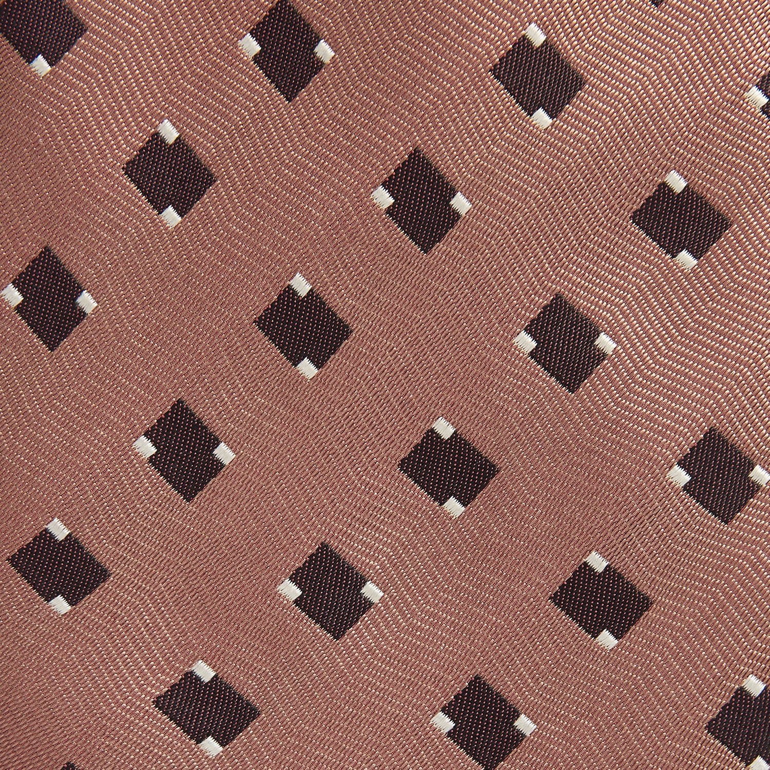 View 2 of product The Bronze and Chocolate Brown Tile Silk Tie by Turnbull & Asser features a classic tile pattern with small black graduation caps, neatly rolled on a plain white background.