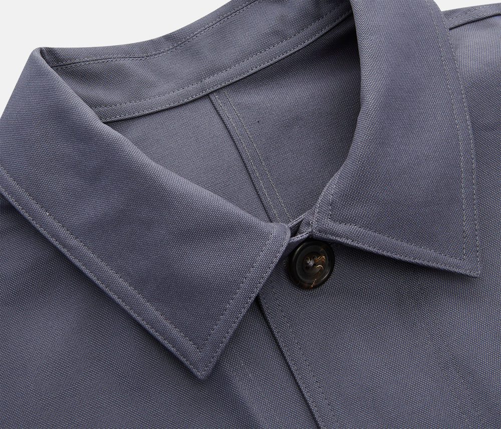 The Turnbull & Asser Charcoal Grey Organic Cotton Blend Remy Chore Jacket features a collar, button-up front, and four front pockets—two chest, two waist—making it a versatile must-have for any men's wardrobe.