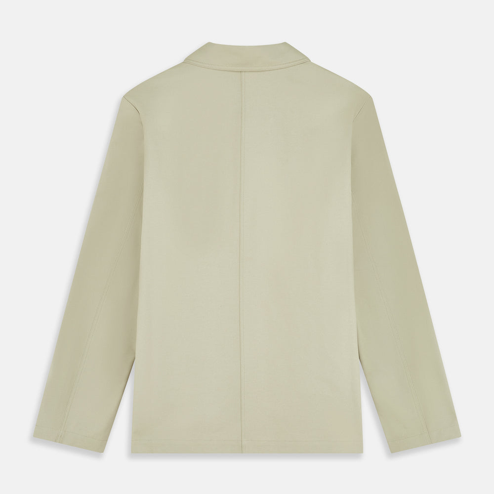 The Turnbull & Asser Tan Organic Cotton Blend Remy Chore Jacket features long sleeves, a collar, button-down front, and three pockets—an essential for any men’s wardrobe. The jacket is shown laid flat on a white background.
