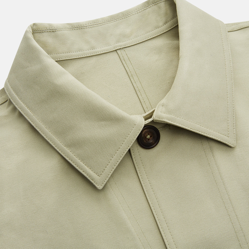 The Turnbull & Asser Tan Organic Cotton Blend Remy Chore Jacket features long sleeves, a collar, button-down front, and three pockets—an essential for any men’s wardrobe. The jacket is shown laid flat on a white background.