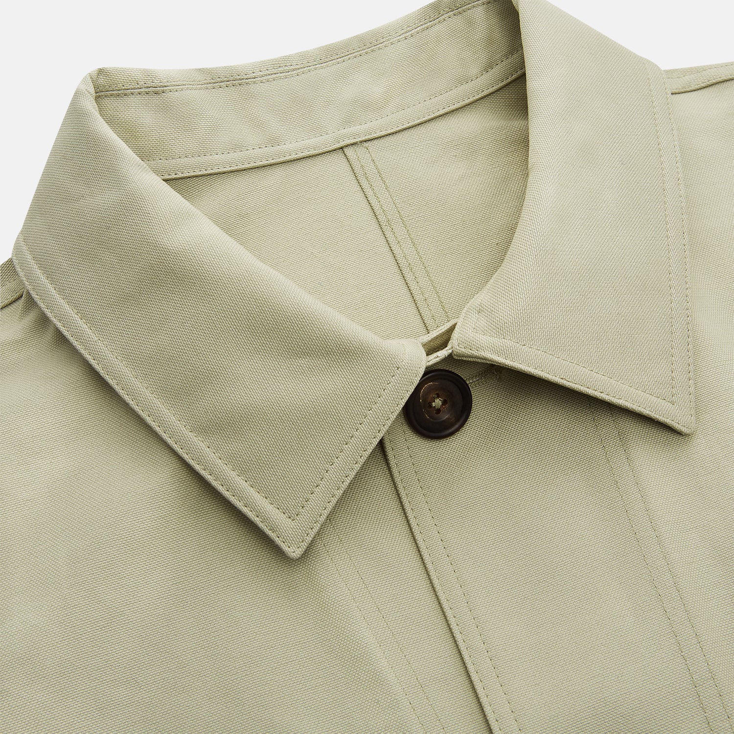 View 2 of product The Turnbull & Asser Tan Organic Cotton Blend Remy Chore Jacket features long sleeves, a collar, button-down front, and three pockets—an essential for any men’s wardrobe. The jacket is shown laid flat on a white background.