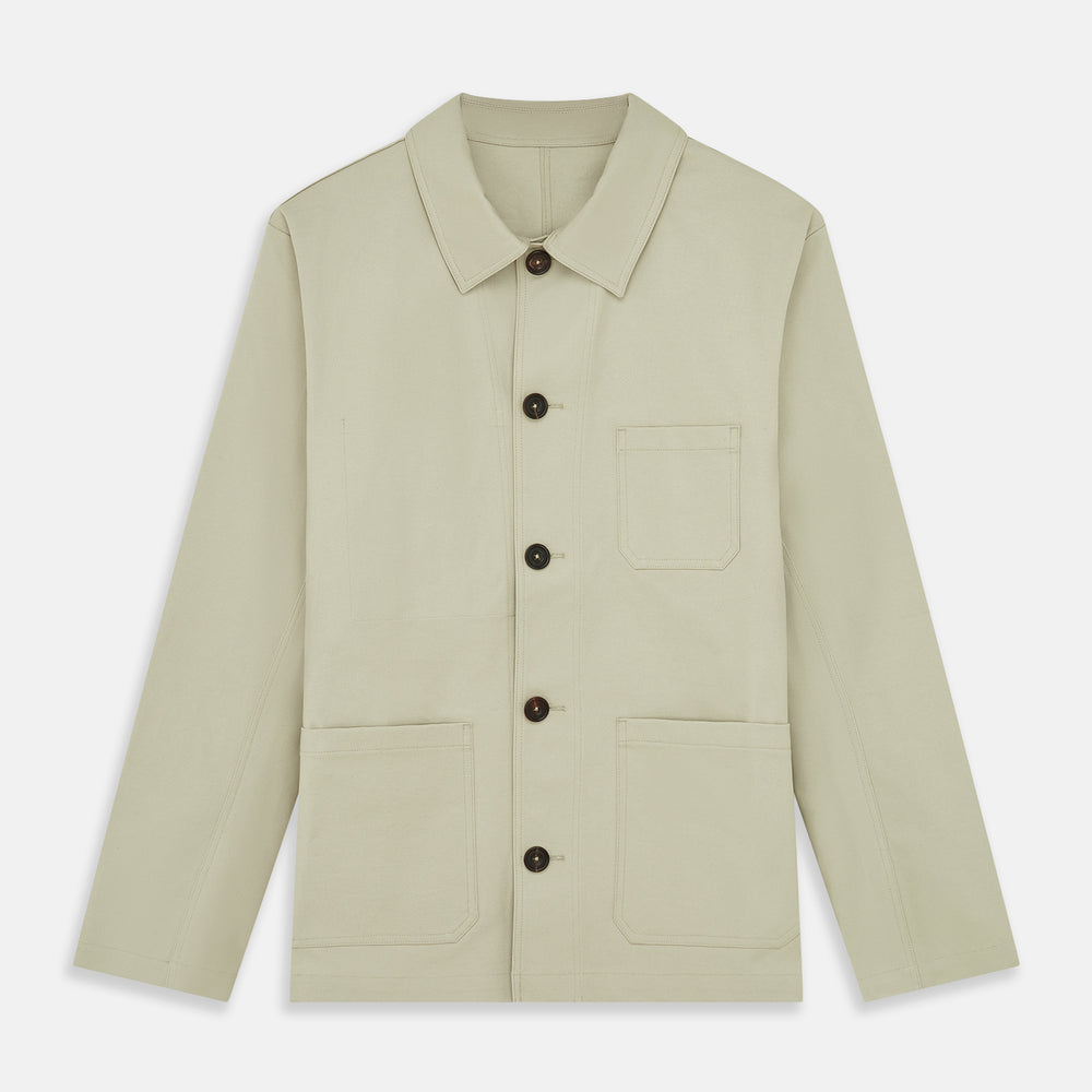 The Turnbull & Asser Tan Organic Cotton Blend Remy Chore Jacket features long sleeves, a collar, button-down front, and three pockets—an essential for any men’s wardrobe. The jacket is shown laid flat on a white background.