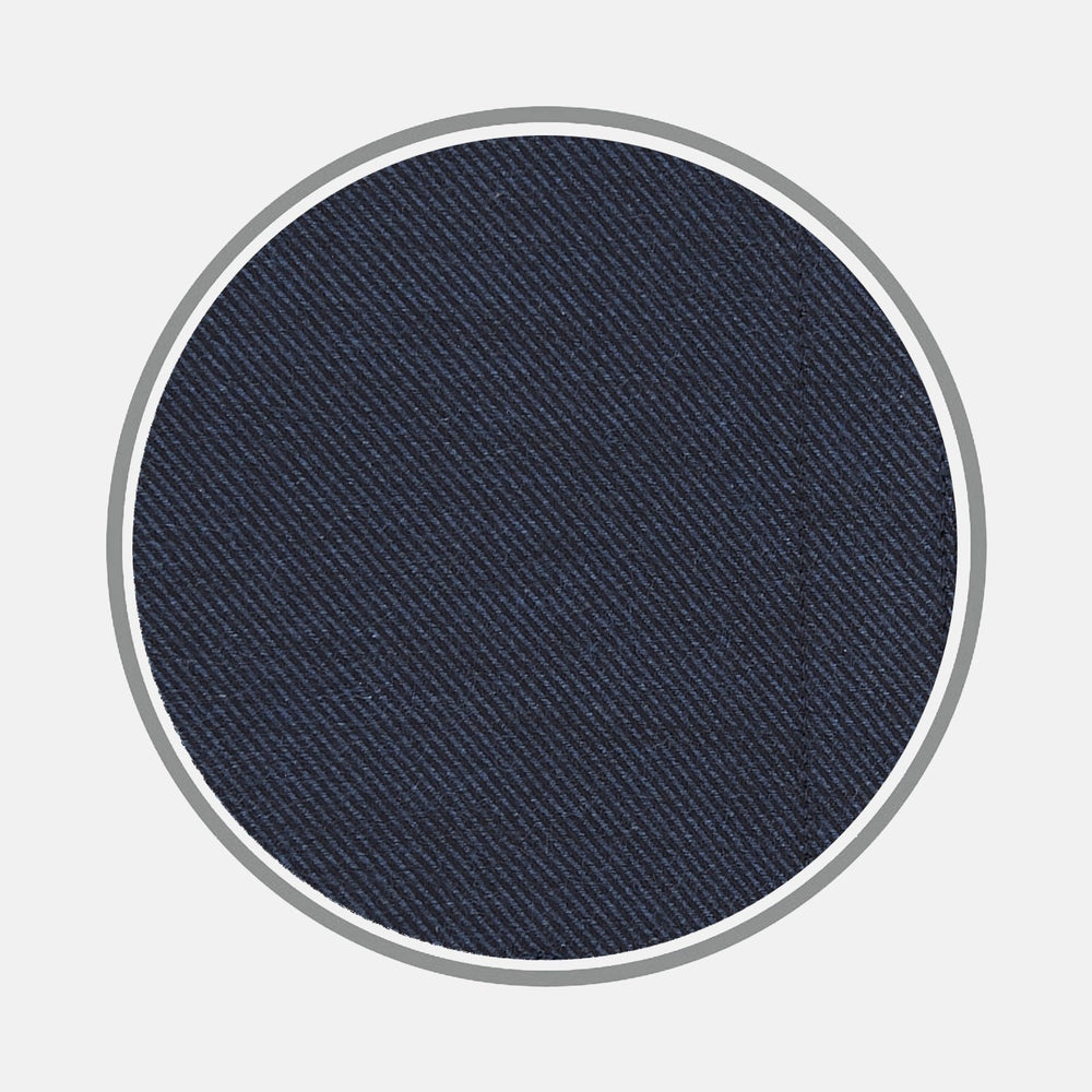 A close-up of Turnbull & Asser’s Navy Cashmere Blend Fabric highlights its dark blue shade and diagonal twill weave, displayed inside a circular frame on a light gray background.