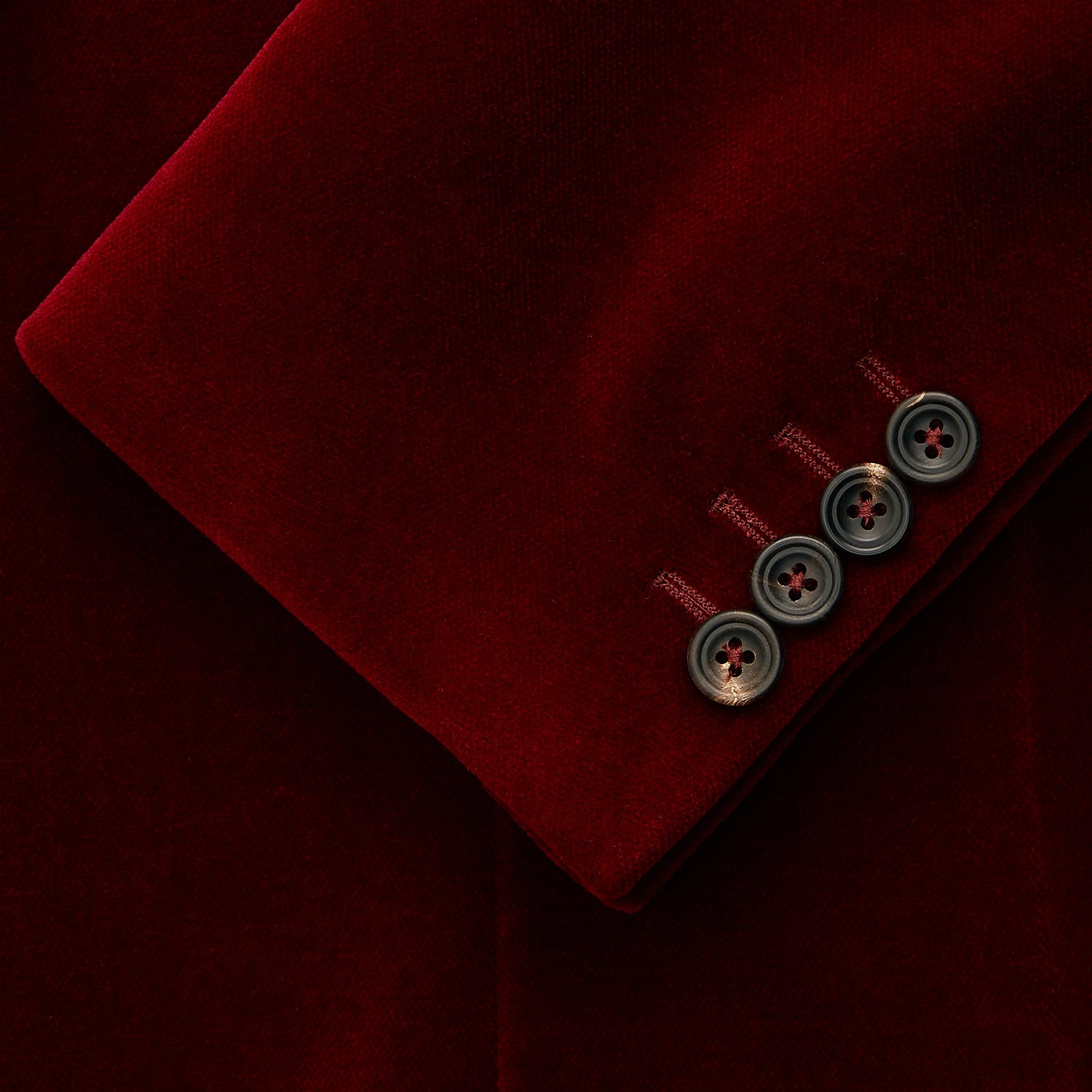 View 3 of product The Turnbull & Asser Wine Velvet Barrington Blazer, tailored in Italy, features a deep red hue, notched lapel, two front buttons, three pockets, and cuff button details. Shown against a plain white background.