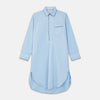 View 1 of product The Turnbull & Asser Light Blue Piped Cotton Nightshirt is a luxurious long-sleeve shirt dress with a pointed collar, black piping on the collar, cuffs, and chest pocket, button front closure, and curved hem.