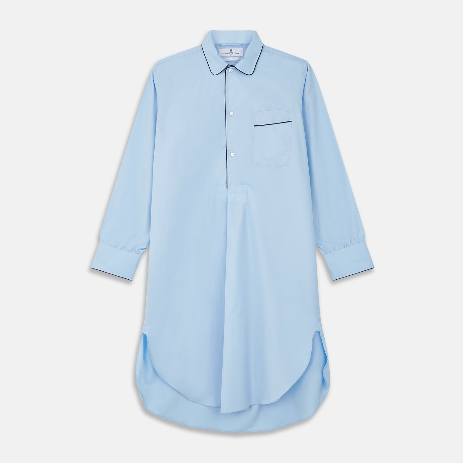 View 1 of product The Turnbull & Asser Light Blue Piped Cotton Nightshirt is a luxurious long-sleeve shirt dress with a pointed collar, black piping on the collar, cuffs, and chest pocket, button front closure, and curved hem.