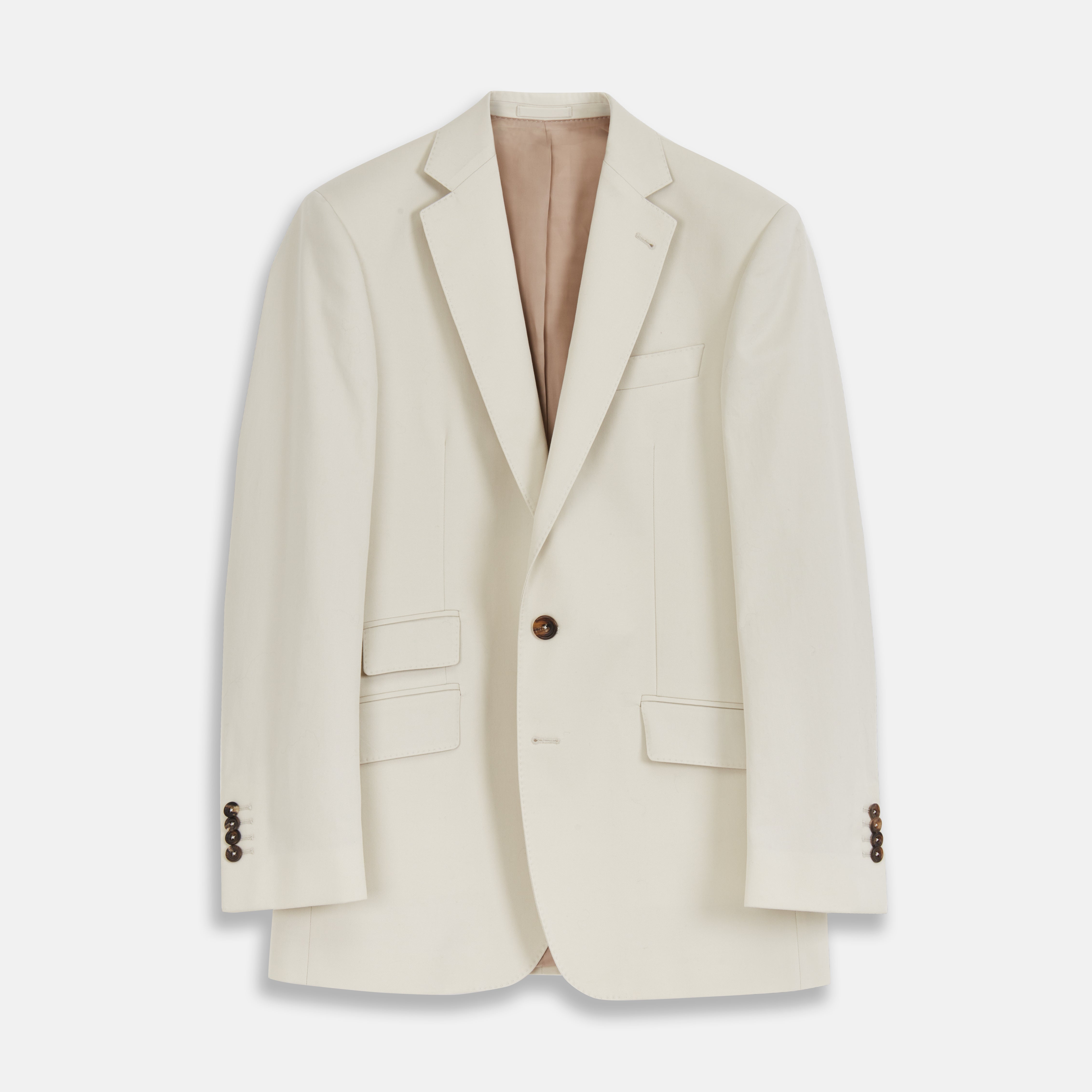 View 1 of product The Turnbull & Asser Stone Cotton Twill Jacket features a notch lapel, chest pocket, two front flap pockets, and brown buttons. Italian-tailored for smart-casual style, it is shown here against a white background.