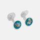 Turnbull & Asser’s Teal Magnolia Hand-painted Cufflinks feature circular sterling silver faces with magnolia designs on a teal background. Each handmade pair is shown on a plain white surface.