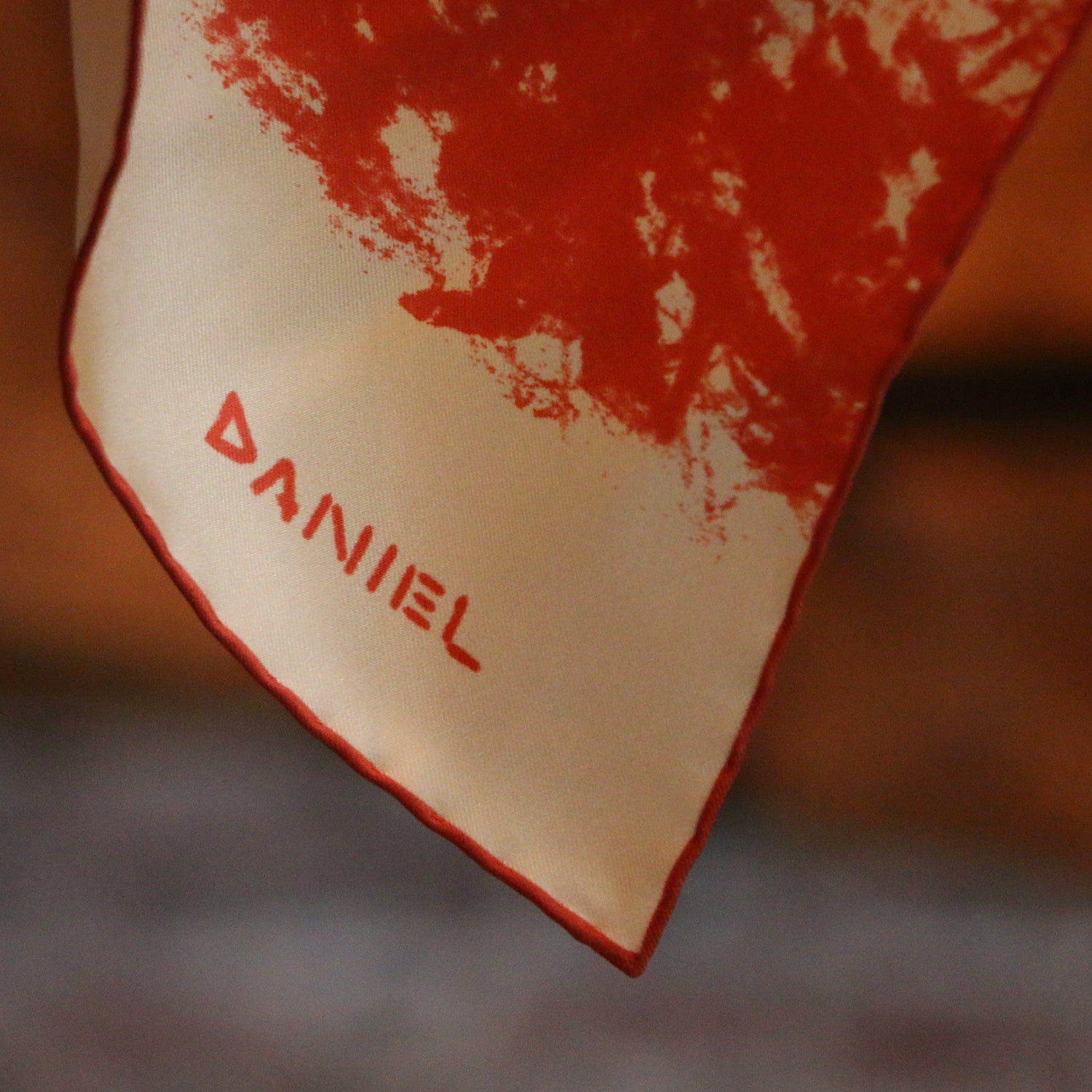 View 3 of product The Turnbull & Asser DANIEL PERKIN BLUE WILDCAT POCKET SQUARE features a blue-toned sketch of a tabby cat’s face with vivid eyes and fine fur detail on a pale blue background, finished with “DANISL” in the lower right corner.