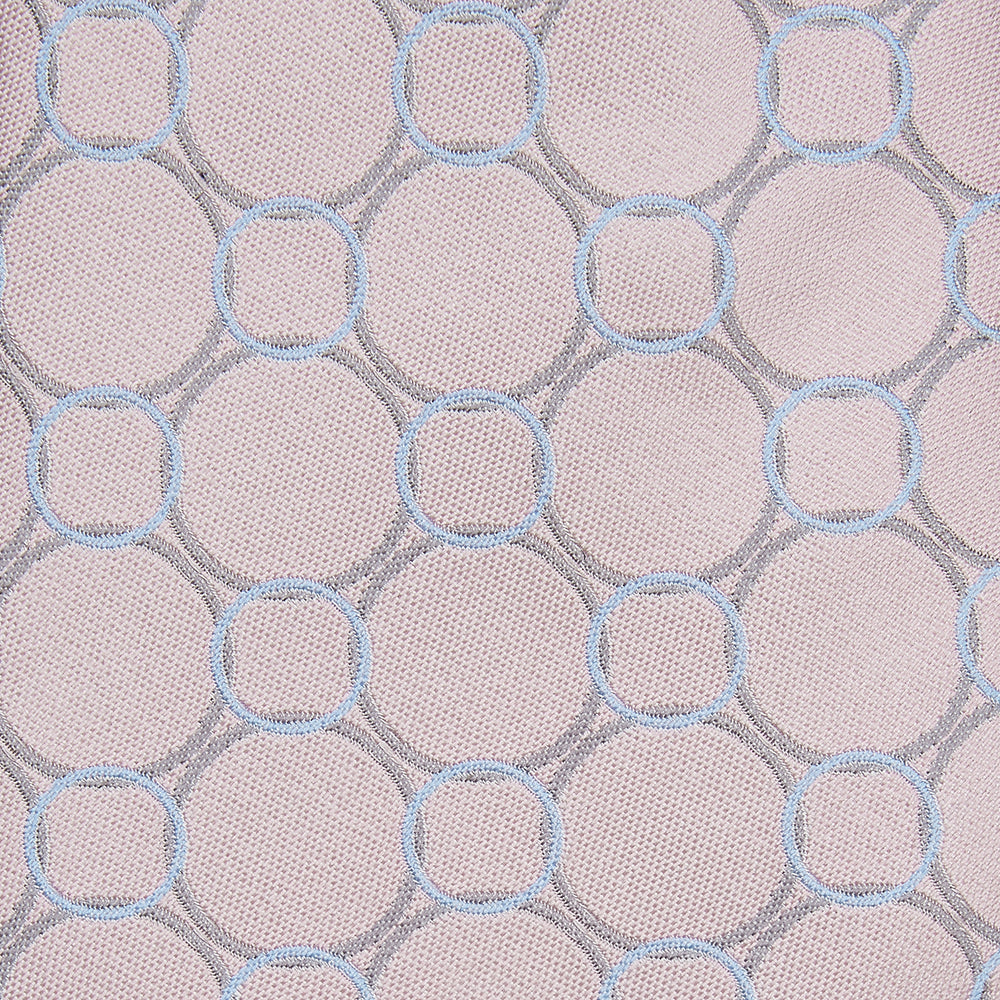 The Turnbull & Asser Baby Pink and Blue Circle Jacquard Silk Tie features a subtle geometric pattern, elegantly rolled against a plain white background.