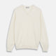 The Turnbull & Asser Cream Cashmere V-Neck Jumper is a luxury knitwear piece with ribbed cuffs and hem, shown laid flat on a white background. Its classic long-sleeve style offers timeless elegance.
