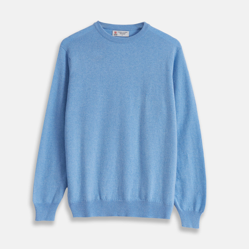 The Turnbull & Asser Sky Blue Fine Cashmere Crew Neck Jumper features long sleeves with ribbed cuffs and hem, shown against a plain white background.