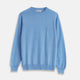 The Turnbull & Asser Sky Blue Fine Cashmere Crew Neck Jumper features long sleeves with ribbed cuffs and hem, shown against a plain white background.
