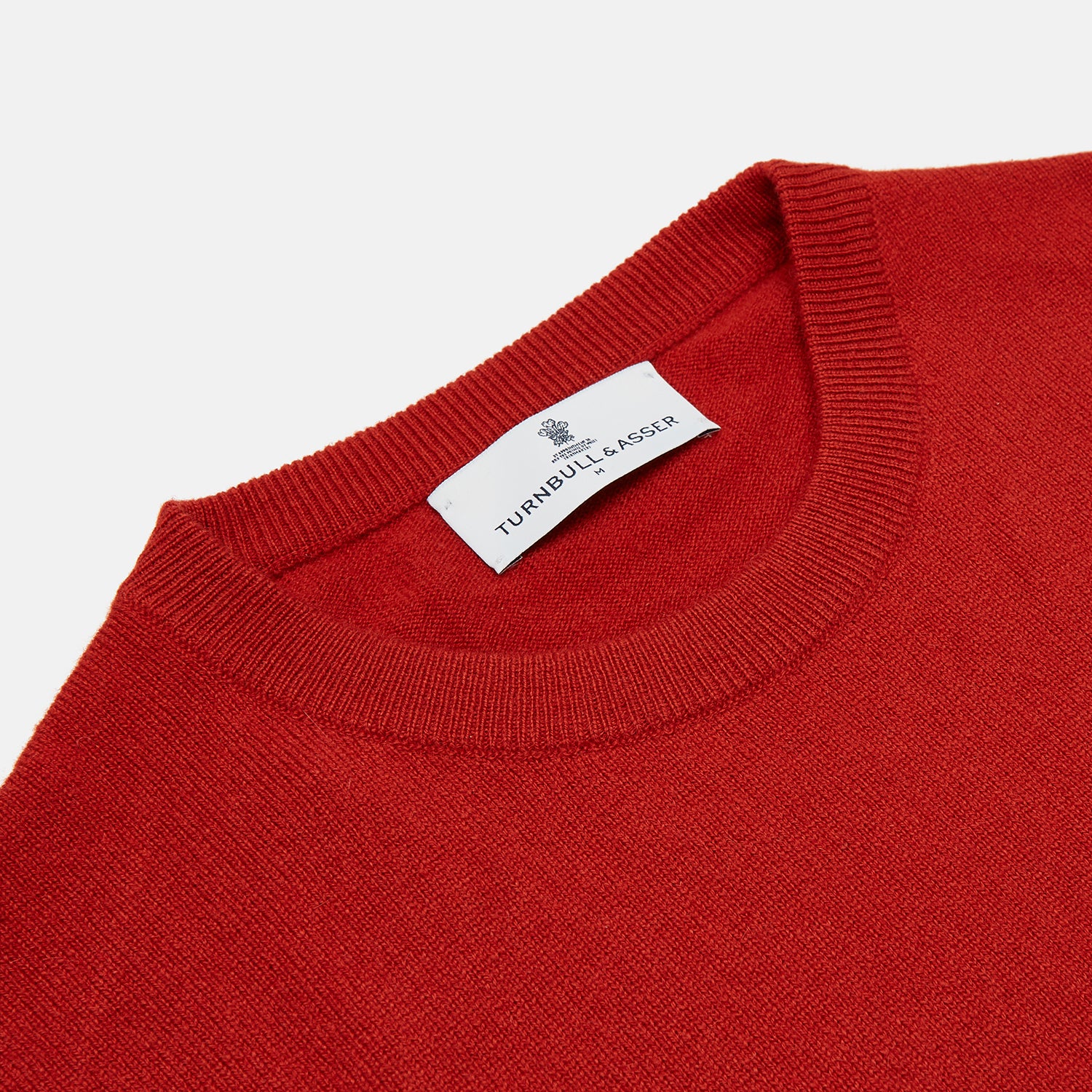 View 2 of product The Turnbull & Asser Red Cashmere Crewneck Jumper features long sleeves, ribbed cuffs and hem, showcasing classic Scottish knitwear elegance. Displayed on a white background.