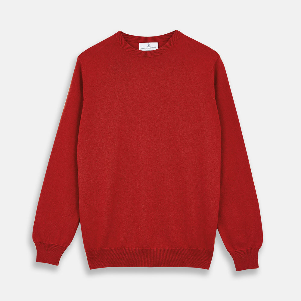 The Turnbull & Asser Red Cashmere Crewneck Jumper features long sleeves, ribbed cuffs and hem, showcasing classic Scottish knitwear elegance. Displayed on a white background.